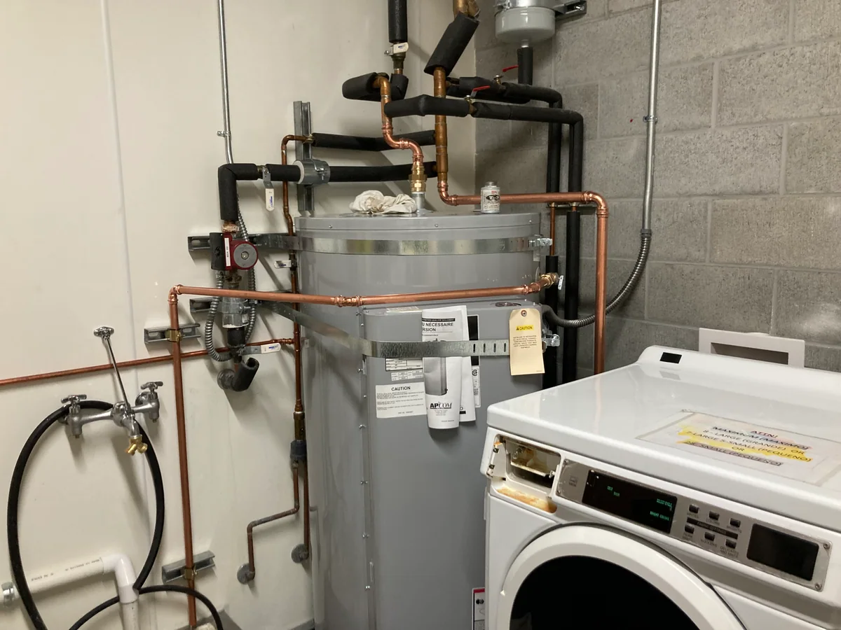 Laundry room water heater piping by Premier Plumbing Solutions 925